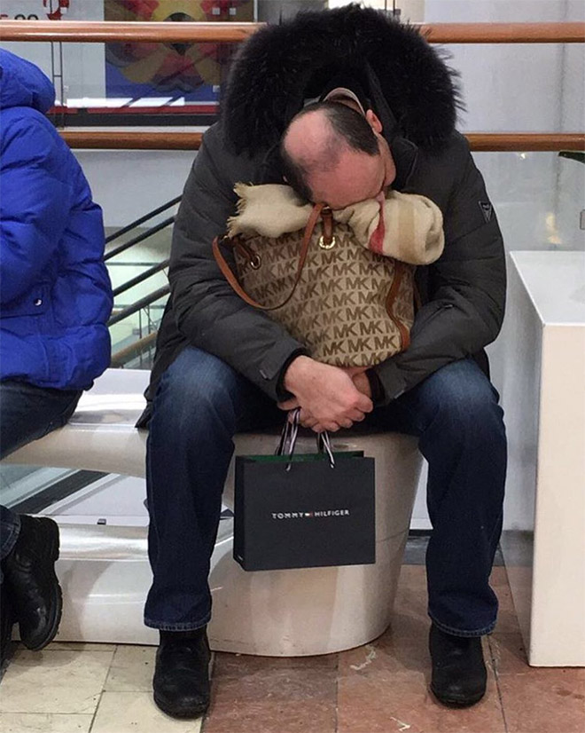 Miserable man trapped in the shopping hell.