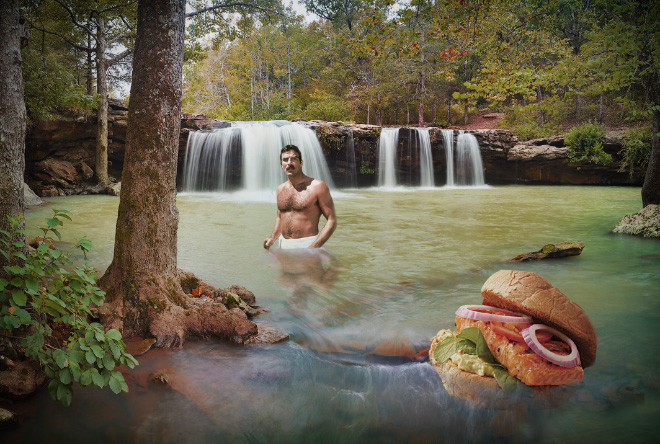 Tom Selleck hanging out with a sandwich in a waterfall.